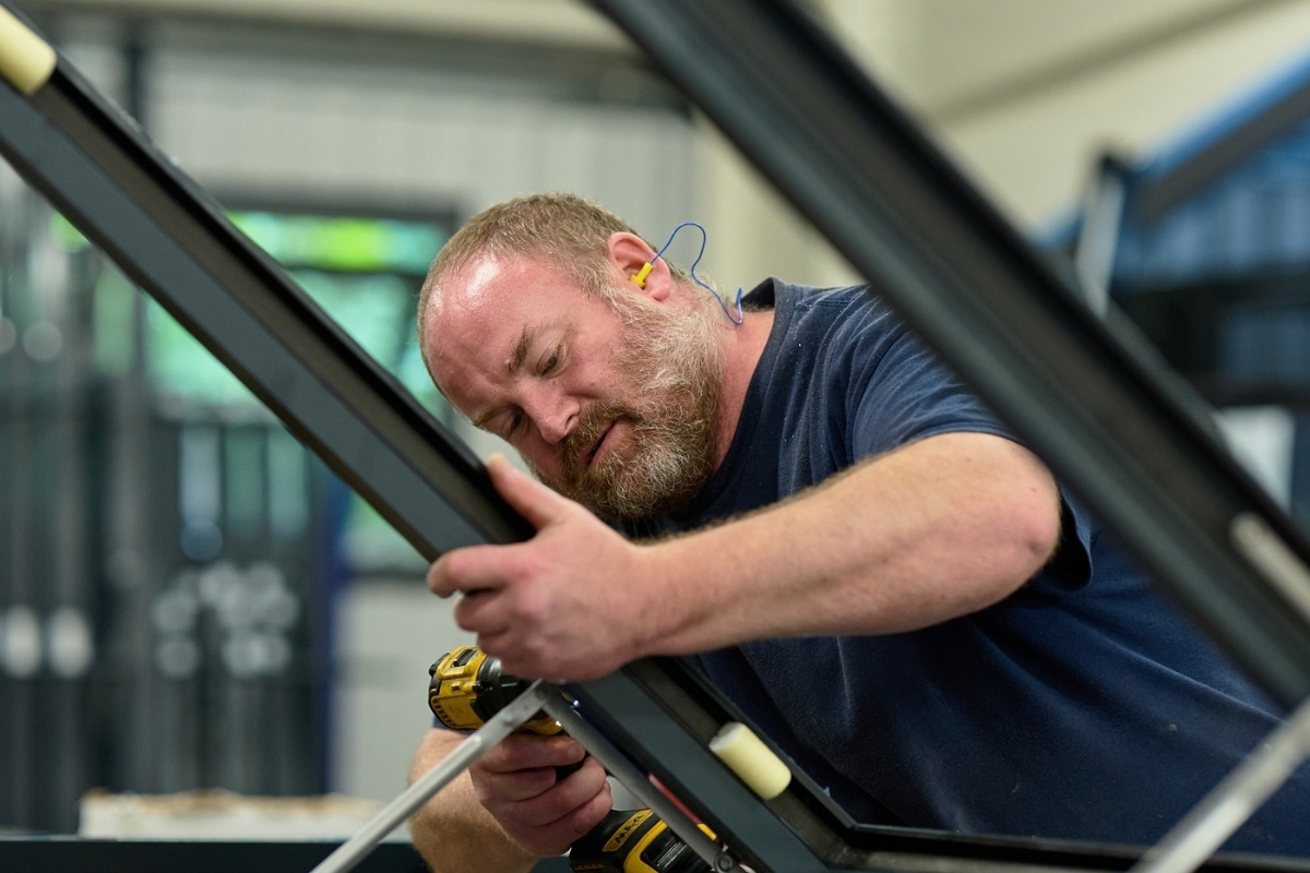 man fabricating aluminium window